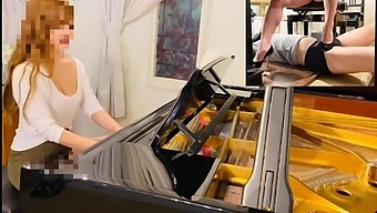Red-Haired Asian Beauty Uses Her High Heels To Tease Her Submissive Partner While Playing The Piano With Her Genitals.